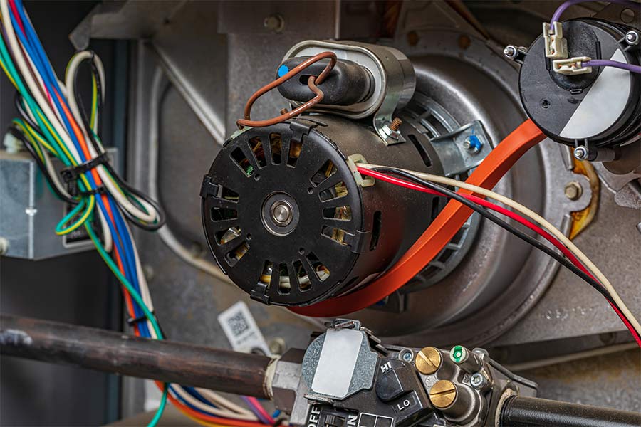 Close-up of an HVAC blower motor with wiring connections