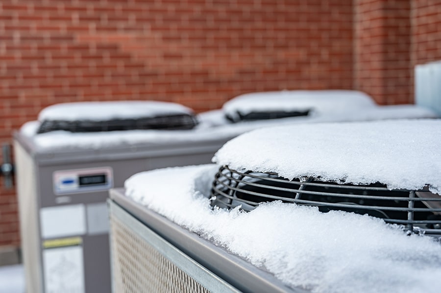 Snow-covered air conditioning units