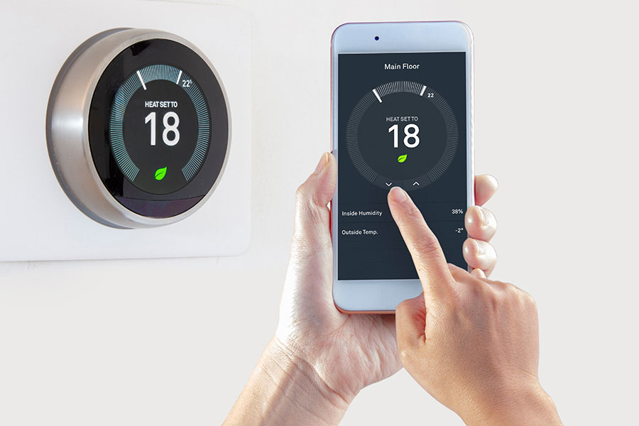 Smart thermostat control displayed on a wall and smartphone